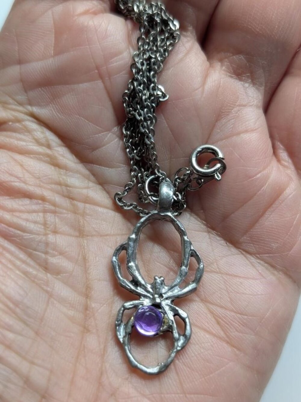 Vintage Halloween Sliver Tone Spider with a Purple Rhinestone Pendant necklace.